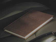 Load image into Gallery viewer, Noteworthy Dogs Notebook showing the dembossed logo on the PU Leather Cover